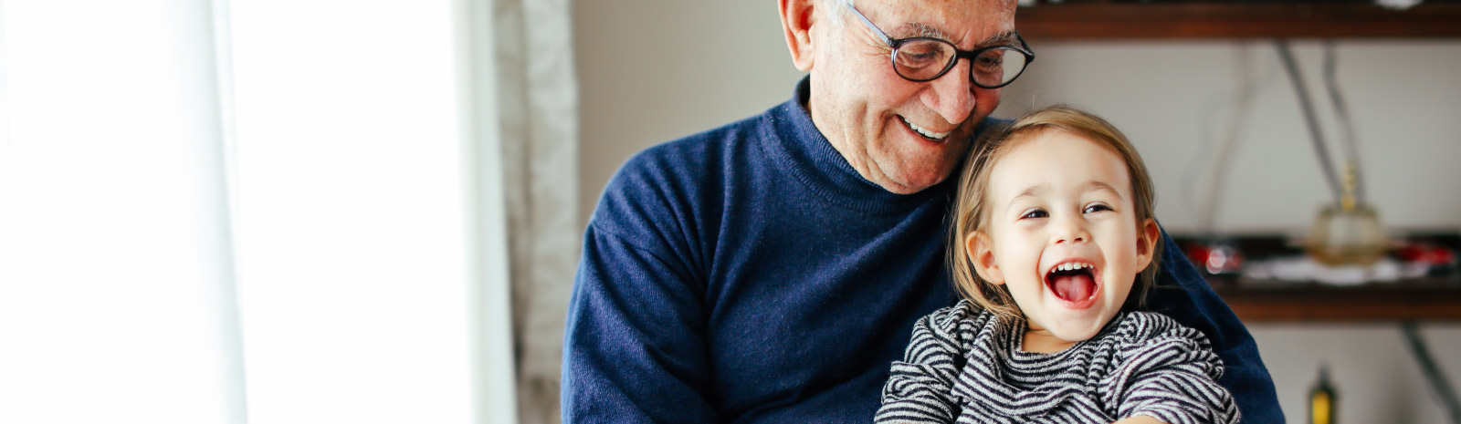 The man joyfully holding a grandchild