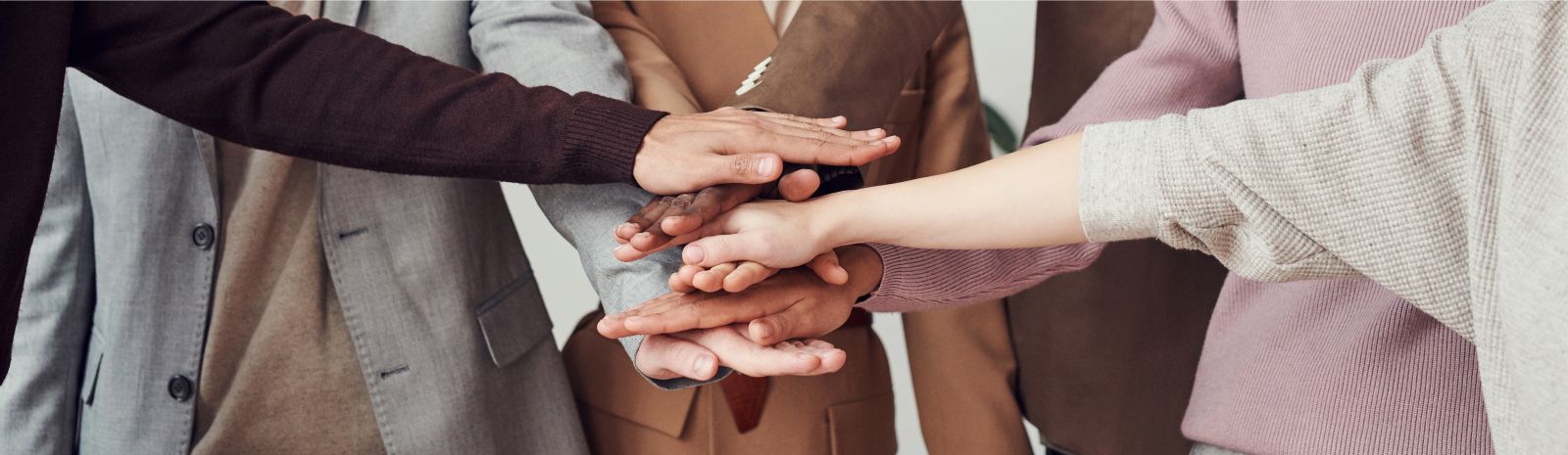 diverse group of stacked hands