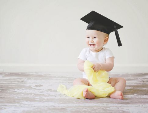 Seated baby in graduation cap